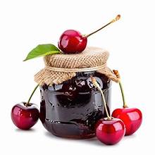 Jar of organic cherry jam with fresh cherries around it