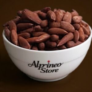 A traditional Chalgoza with its carved body and mouthpiece resting on a fabric backdrop.