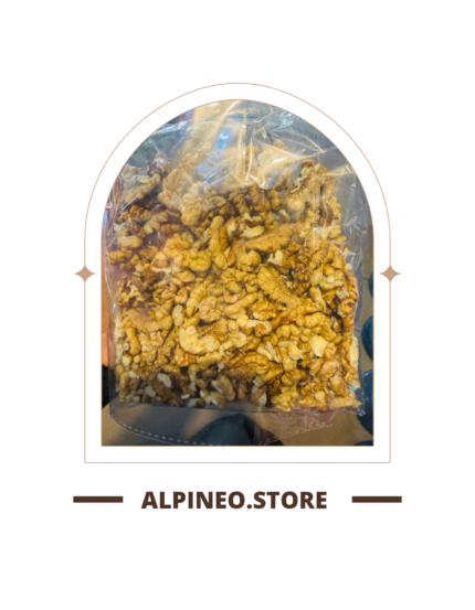 A close-up of a Kaghazi akhrot (walnut) shell, light brown with subtle veins, resting on a neutral surface.