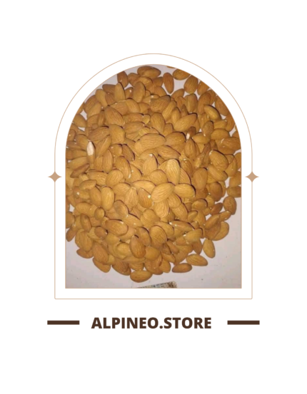 A close-up of a Kaghazi badam shell, pale beige, textured with natural ridges, resting on a wooden surface.